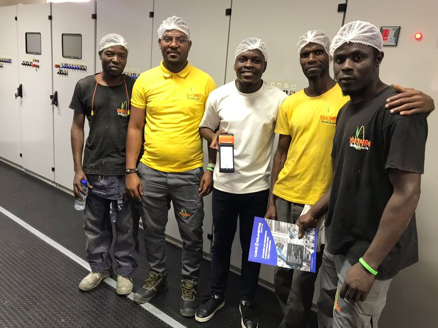 The Yokimbo team with the mobile terminal, at the factory